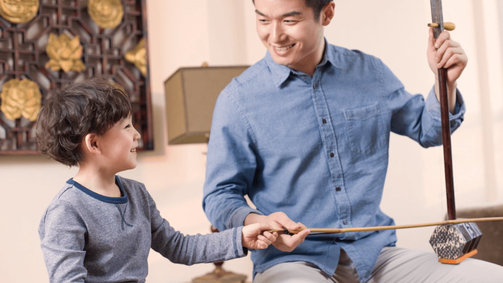 Erhu teacher helping with erhu lessons at Ping's Music School